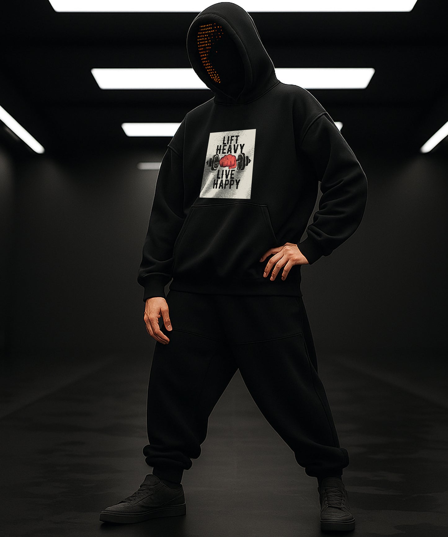 Person wearing a black hoodie with a graphic design on a dark background