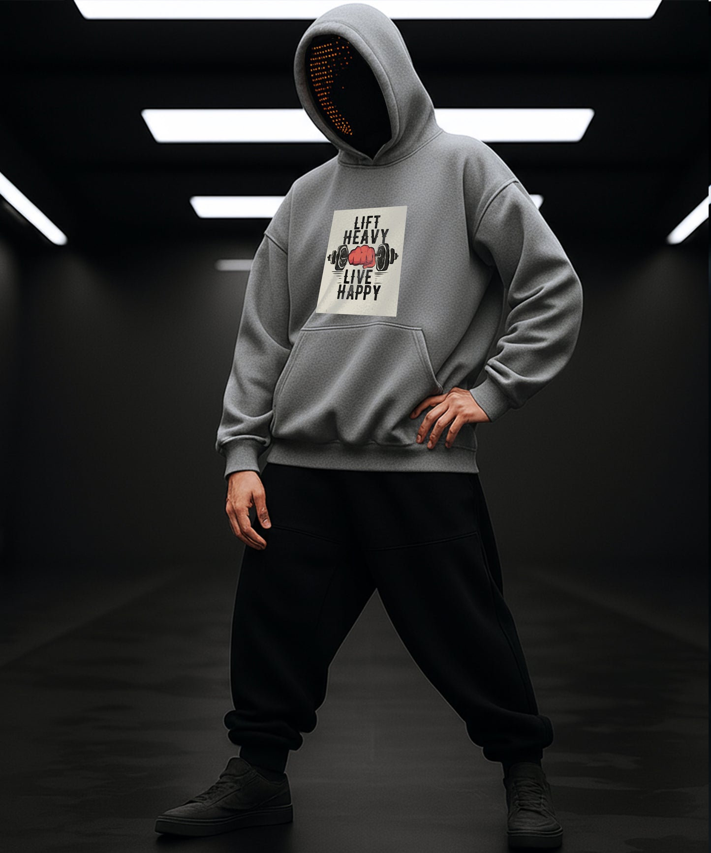 Person wearing a gray hoodie with a printed design on a dark background